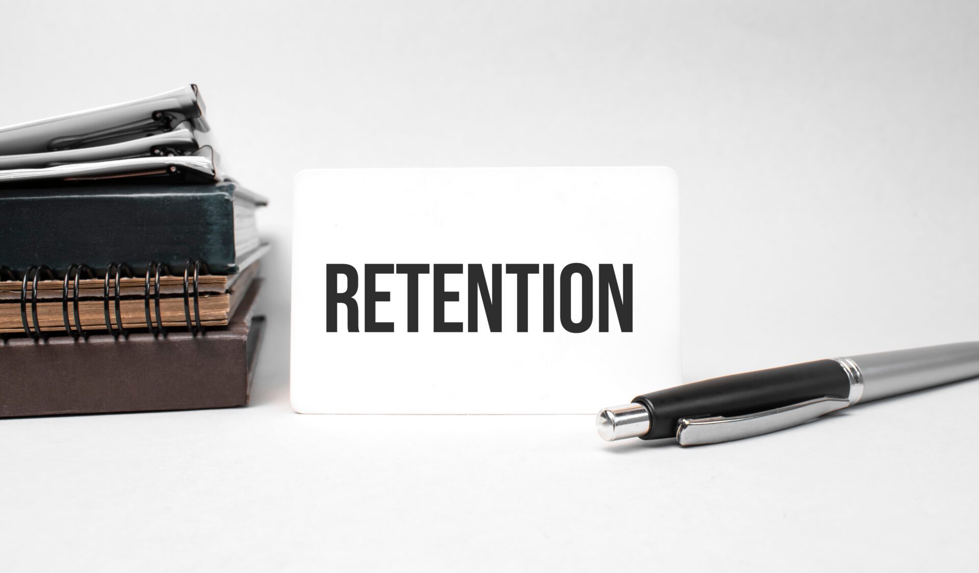 Paper plate, glasses, notepad in stack,pen and text retention on business card